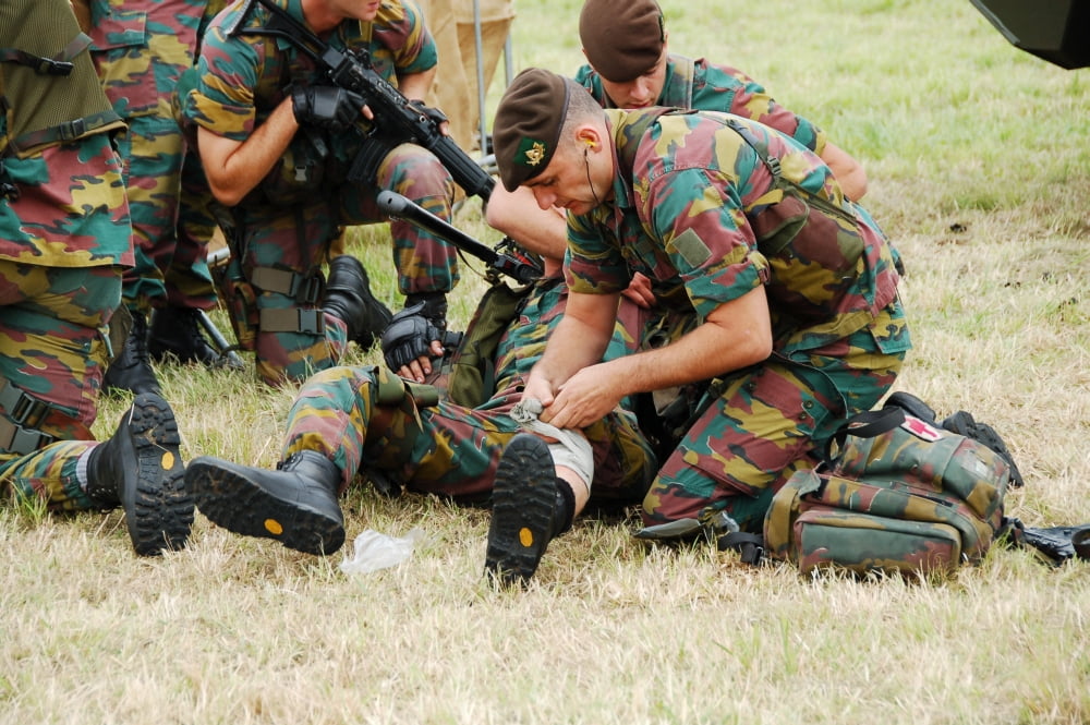 Soldiers of a Belgian Infantry unit helping out a wounded colleague on the field Canvas Art - Luc De JaegerStocktrek Images (34 x 23)