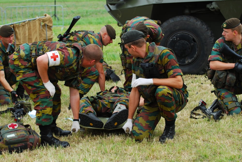 Soldiers of a Belgian Infantry unit helping out a wounded colleague on the field Canvas Art - Luc De JaegerStocktrek Images (34 x 23)