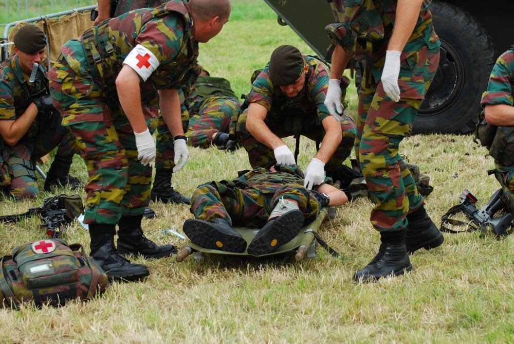 Soldiers of a Belgian Infantry unit helping out a wounded colleague on the field Canvas Art - Luc De JaegerStocktrek Images (34 x 23)