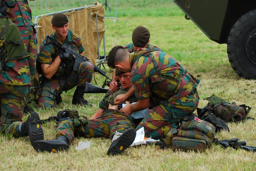 Soldiers of a Belgian Infantry unit helping out a wounded colleague on the field Canvas Art - Luc De JaegerStocktrek Images (34 x 23)