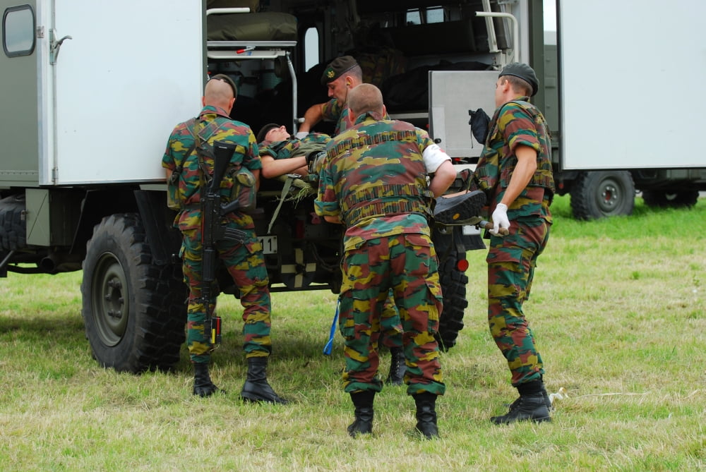 Soldiers of a Belgian Infantry unit helping out a wounded colleague on the field Canvas Art - Luc De JaegerStocktrek Images (34 x 23)