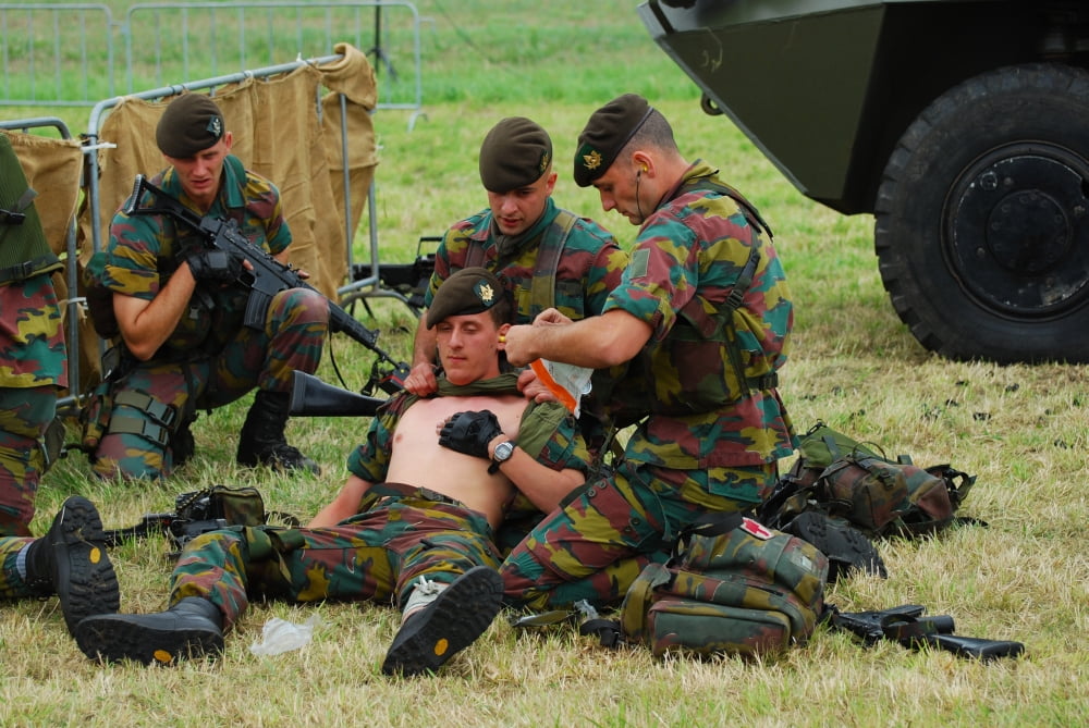 Soldiers of a Belgian Infantry unit helping out a wounded colleague on the field Canvas Art - Luc De JaegerStocktrek Images (34 x 23)