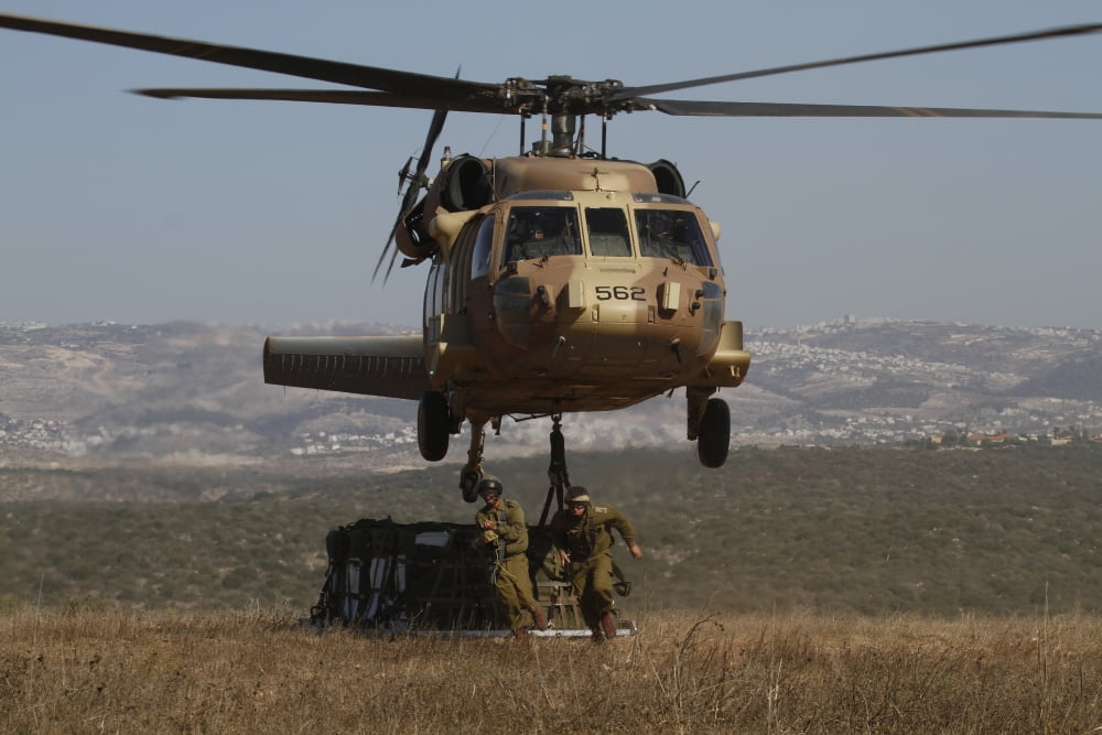 Soldiers practice external cargo mounting on a UH-60 Yanshuf of the Israel Air Force Canvas Art - Ofer ZidonStocktrek Images (34 x 23)