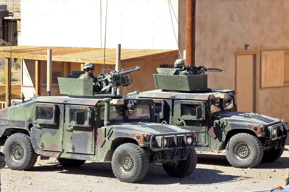Soldiers provide overwatch for fellow troops entering a mock village during training Canvas Art - Stocktrek Images (35 x 23)
