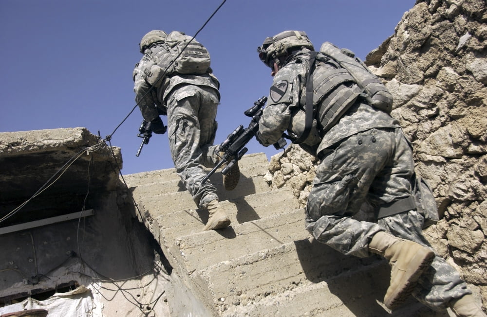 Soldiers running up staircase of a building during a mission in Mosul Iraq Canvas Art - Stocktrek Images (35 x 23)