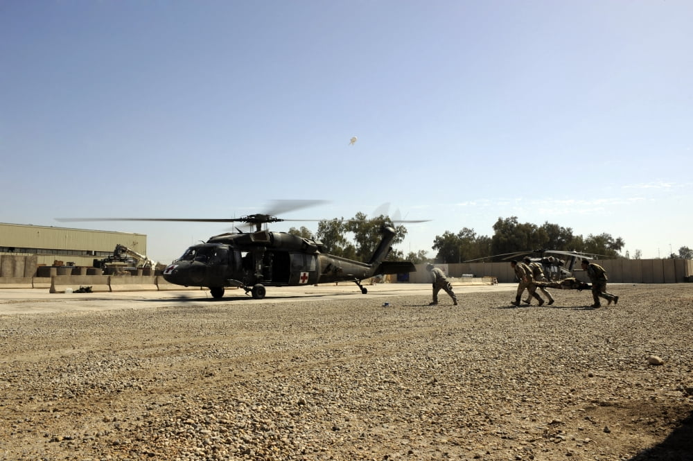 Soldiers rush a simulated casualty to a UH-60 Blackhawk helicopter Canvas Art - Stocktrek Images (34 x 23)