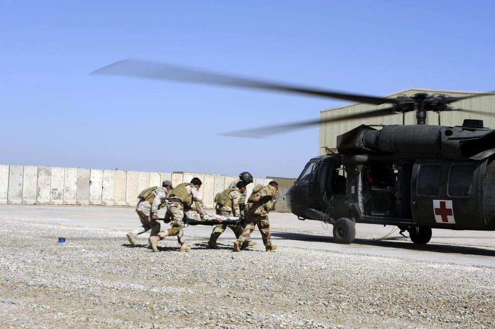 Soldiers rush a simulated casualty to a UH-60 Blackhawk helicopter Canvas Art - Stocktrek Images (34 x 23)