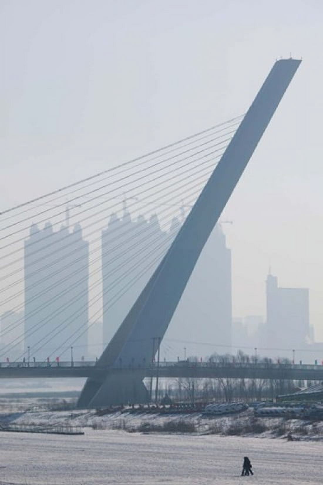 Songhuajiang Highway Bridge across the frozen Songhua River with buildings in the background Harbin China Canvas Art - Panoramic Images (24 x 36)