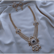 South Indian Bollywood Peacock Design Multilayer Gold-Plated Haram Necklace Set   AD CZ Multicolor Kemp Stones with Matte Finish, Pearl Jhumka Drops & Matching Earrings.