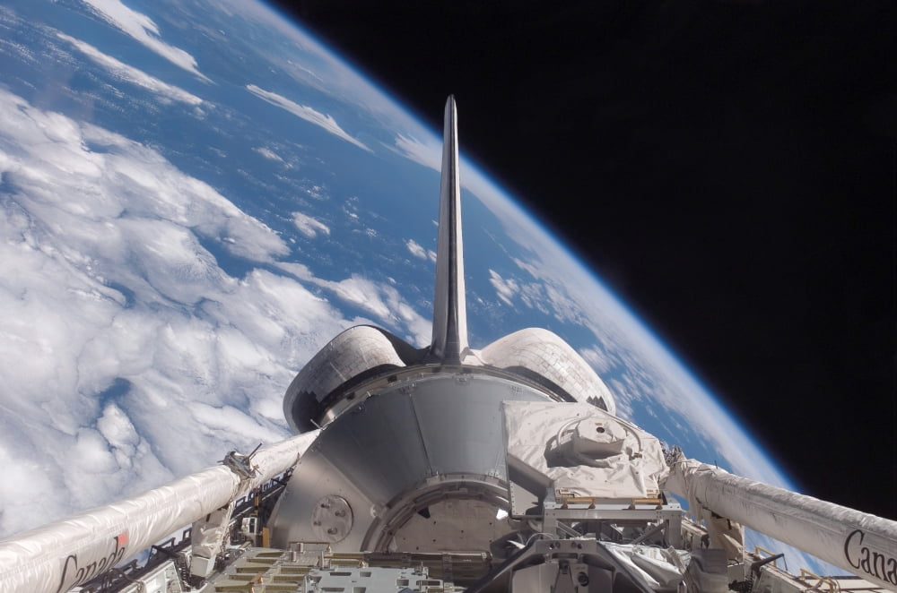 Space Shuttle Discovery backdropped by Earth Canvas Art - Stocktrek Images (34 x 23)