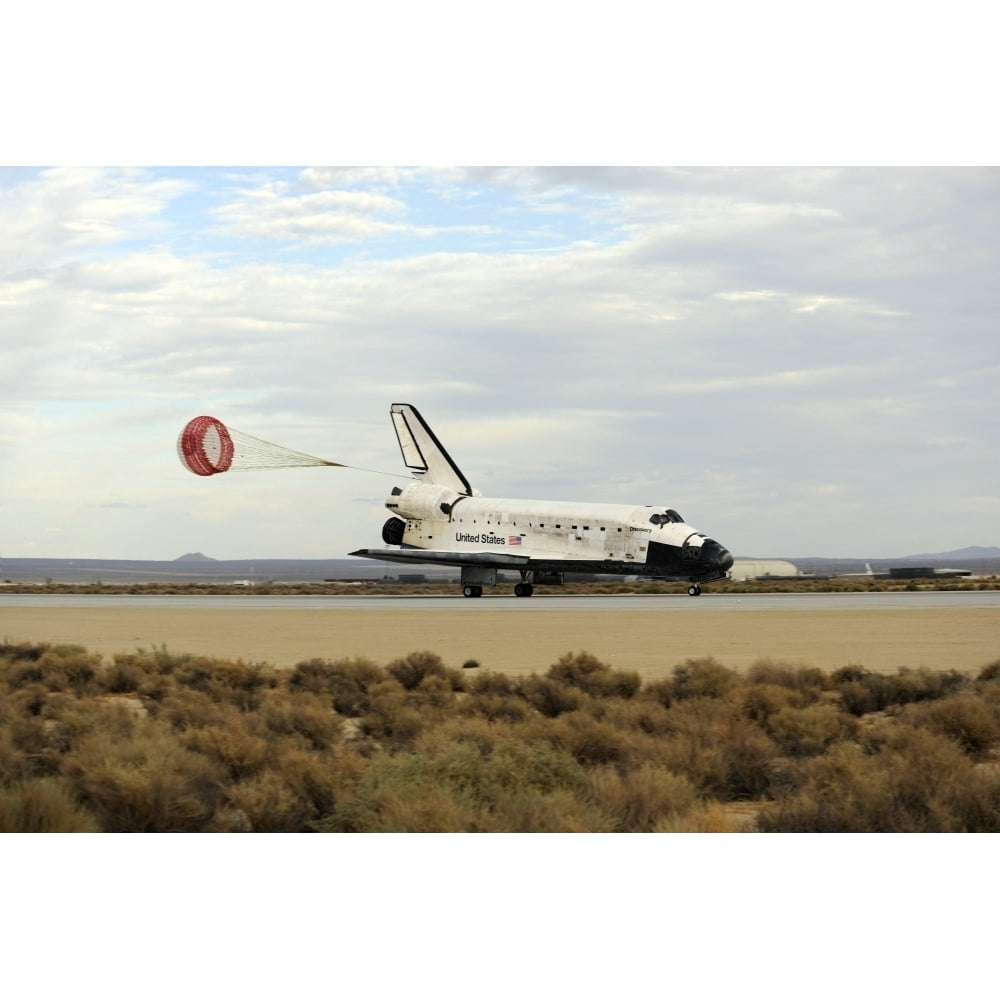 Space Shuttle Discovery deploys its drag chute as the vehicle comes to ...