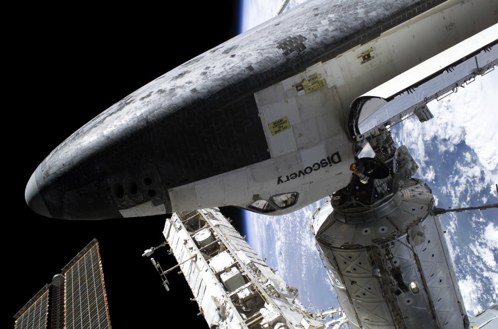 Space Shuttle Discovery docked to the International Space Station Canvas Art - Stocktrek Images (34 x 23)