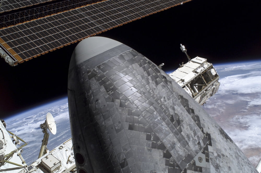Space Shuttle Discovery docked to the International Space Station Canvas Art - Stocktrek Images (34 x 23)