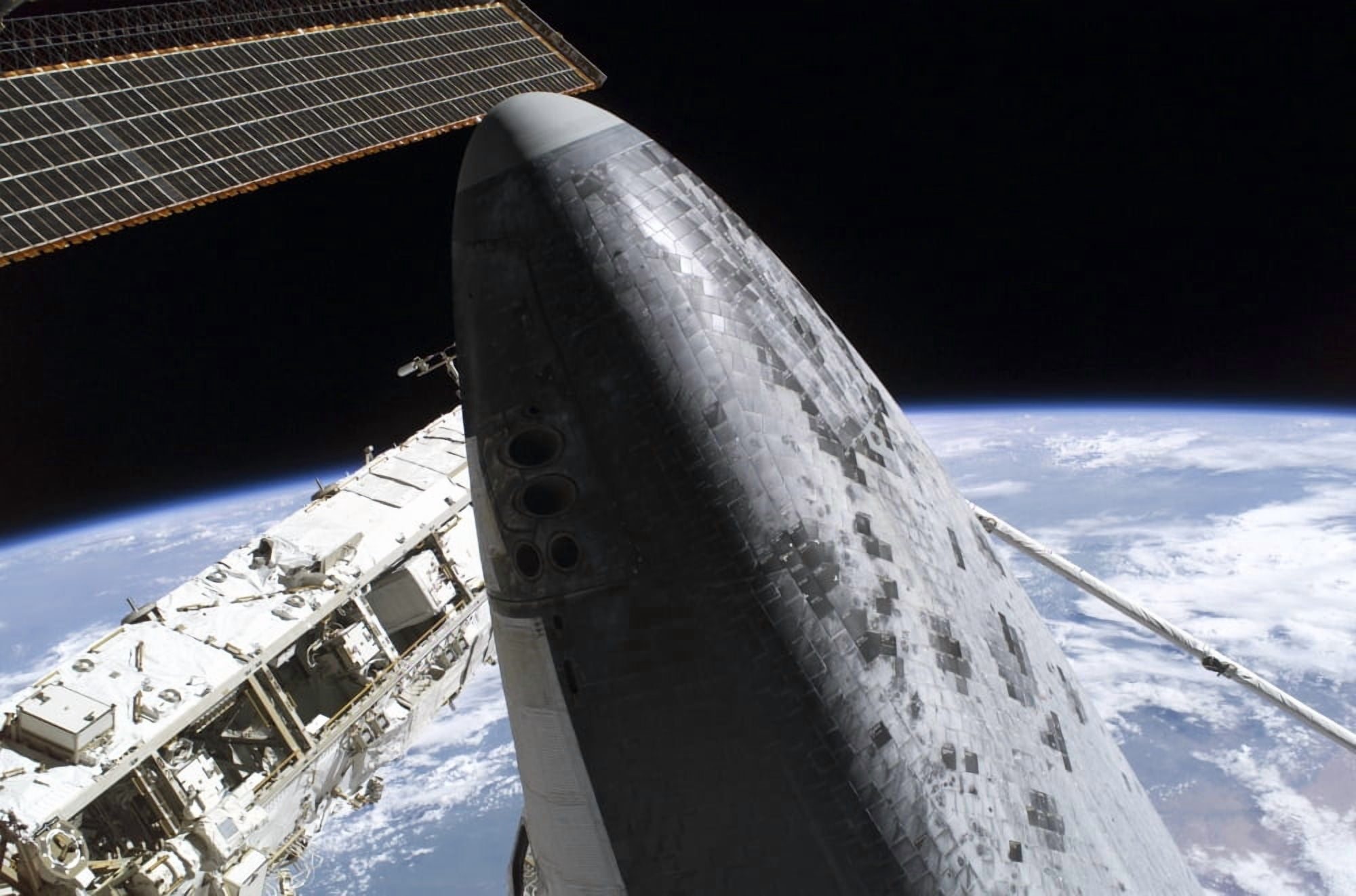Space Shuttle Discovery docked to the International Space Station Canvas Art - Stocktrek Images (34 x 23)