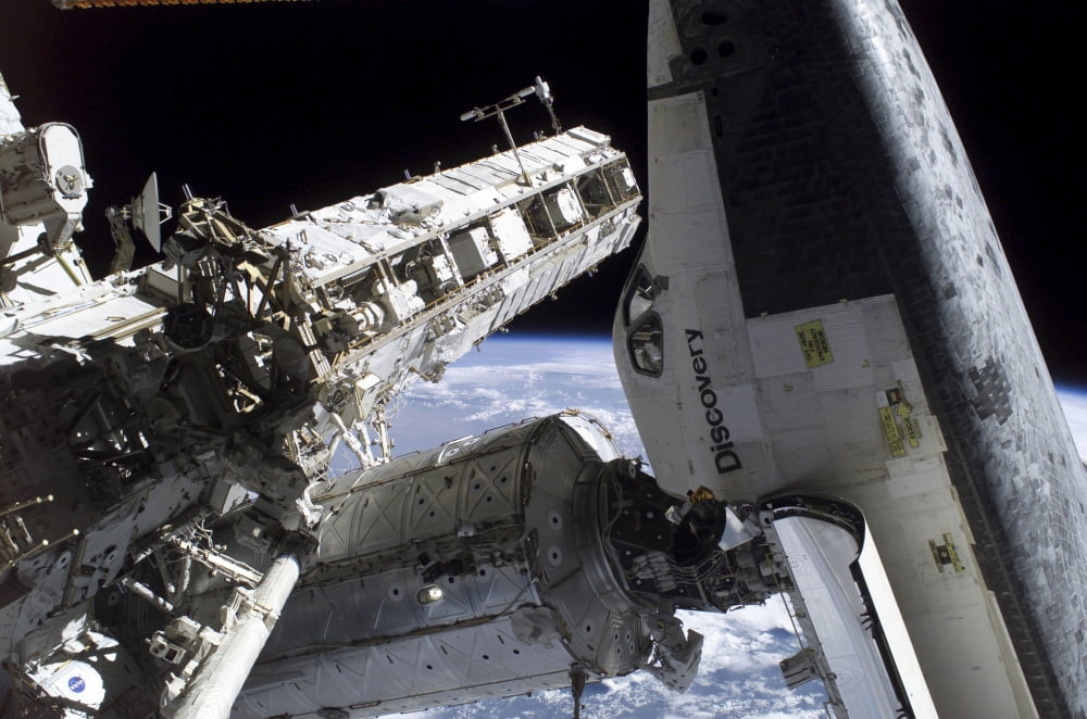 Space Shuttle Discovery docked to the International Space Station Canvas Art - Stocktrek Images (34 x 23)