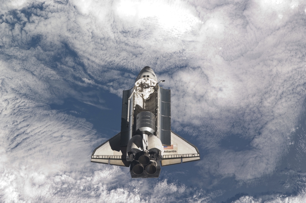 Space shuttle Atlantis above a cloud covered Earth Canvas Art - Stocktrek Images (34 x 23)