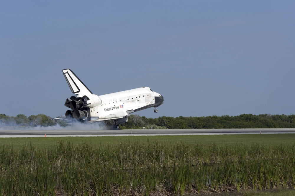 Space shuttle Discovery lands on Runway 33 at the Shuttle Landing Facility at Kennedy Space Center in Florida Canvas Art - Stocktrek Images (34 x 23)