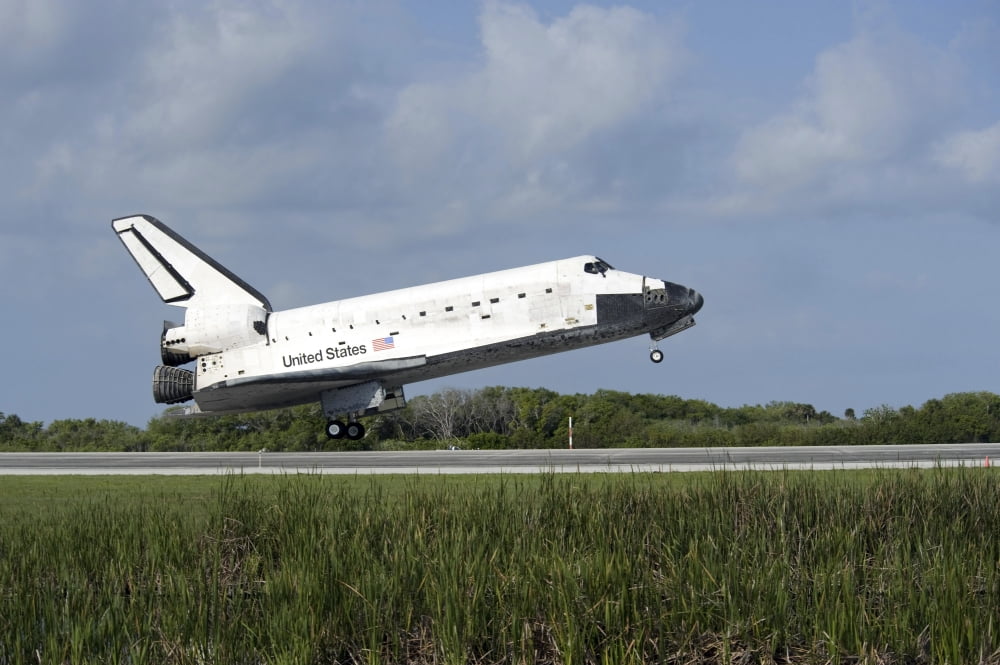 Space shuttle Discovery lands on Runway 33 at the Shuttle Landing Facility at Kennedy Space Center in Florida Canvas Art - Stocktrek Images (34 x 23)