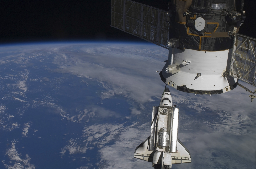 Space shuttle Endeavour as it approaches a docked Russian spacecraft Canvas Art - Stocktrek Images (34 x 23)