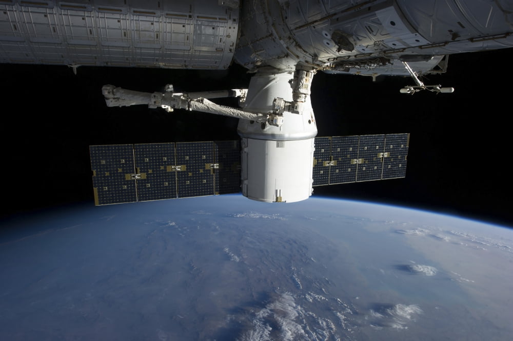 SpaceX Dragon during its docking with the International Space Station Canvas Art - Stocktrek Images (35 x 23)