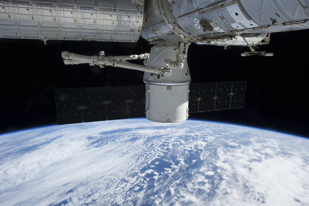 SpaceX Dragon during its docking with the International Space Station Canvas Art - Stocktrek Images (35 x 23)