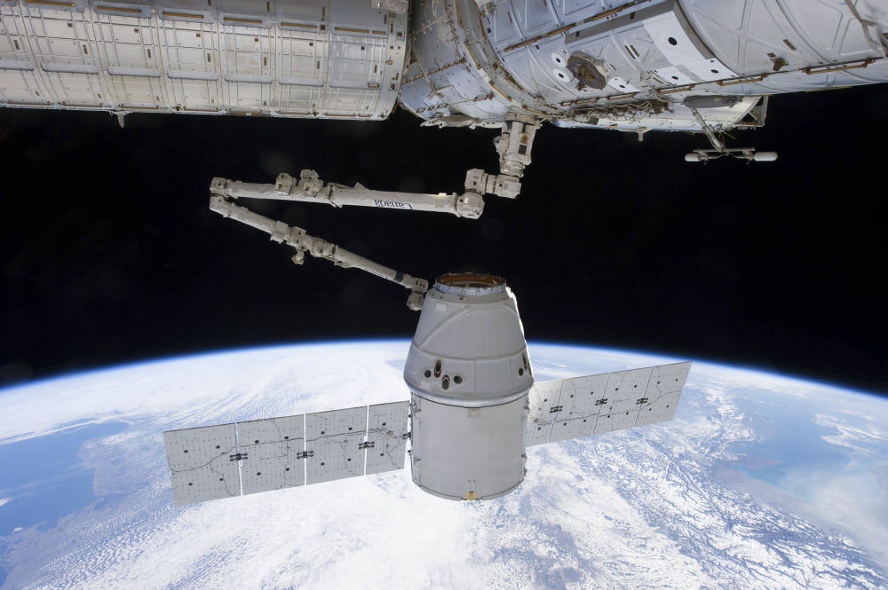 SpaceX Dragon during its docking with the International Space Station Canvas Art - Stocktrek Images (35 x 23)
