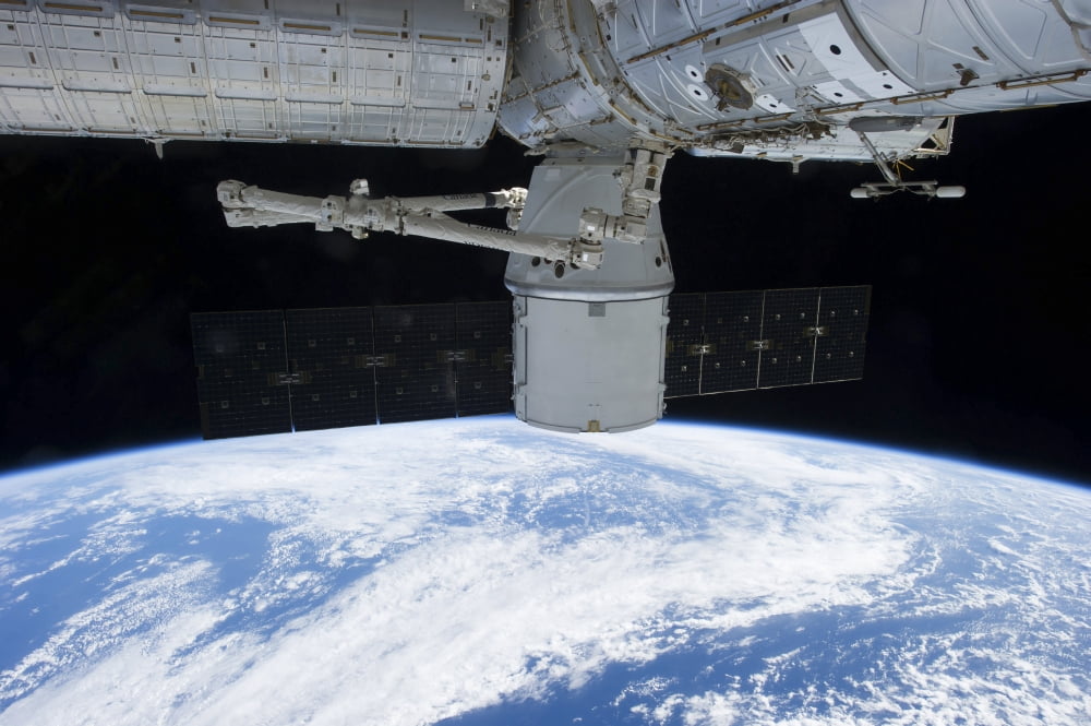 SpaceX Dragon during its docking with the International Space Station Canvas Art - Stocktrek Images (35 x 23)