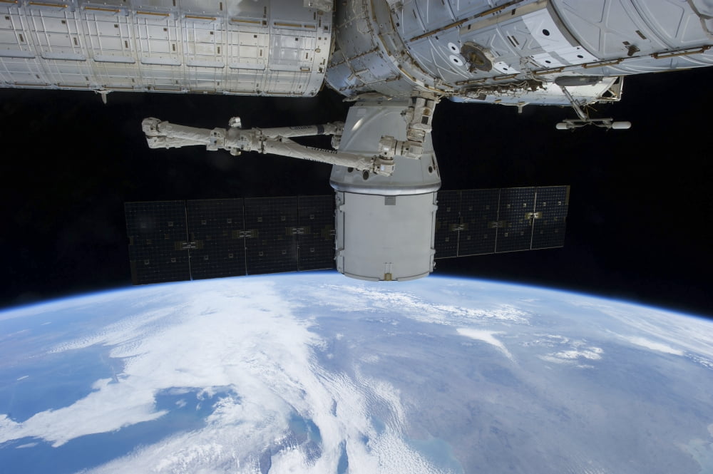 SpaceX Dragon during its docking with the International Space Station Canvas Art - Stocktrek Images (35 x 23)
