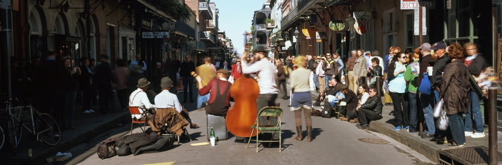 Spectator looking at street musician performing Bourbon Street New Orleans Louisiana USA Canvas Art - Panoramic Images (27 x 9)