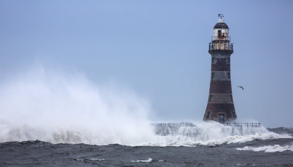 Splashing water from a crashing wave against a lighthouseSunderland Tyne and Wear England Canvas Art - John Short Design Pics (40 x 22)