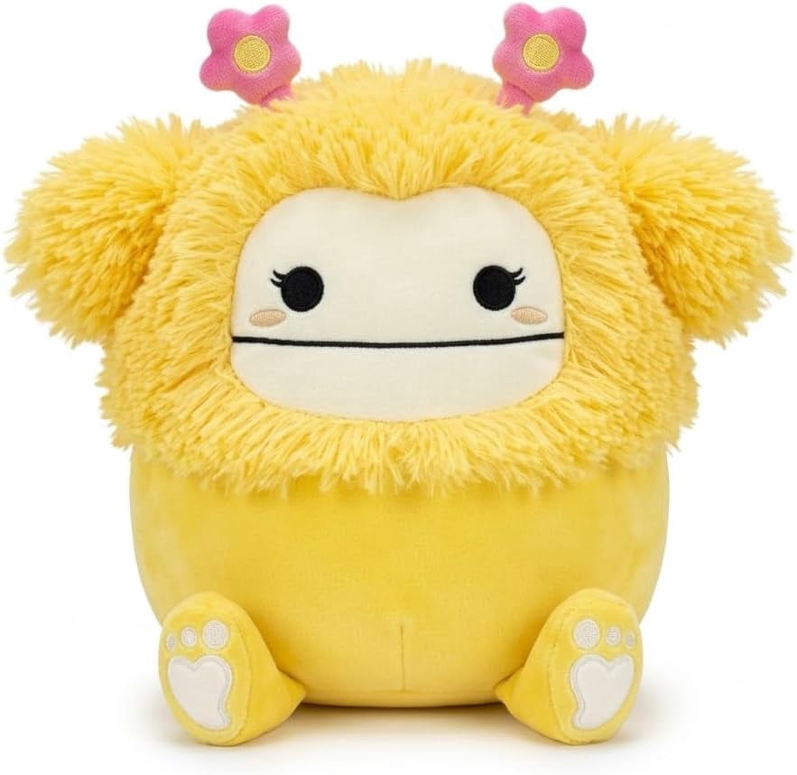 Squishmallows 8 Inch Nomi Easter Plush Toy, Yellow Bigfoot, Fuzzy Hair with Pink Flower Accents