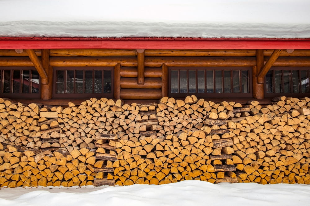 Stacked wood against snow covered building Canvas Art - Panoramic Images (24 x 36)