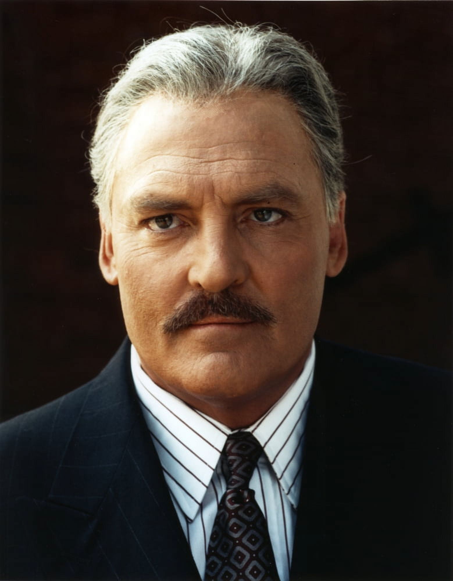 Stacy Keach Posed in Black Background Portrait wearing Tuxedo Photo
