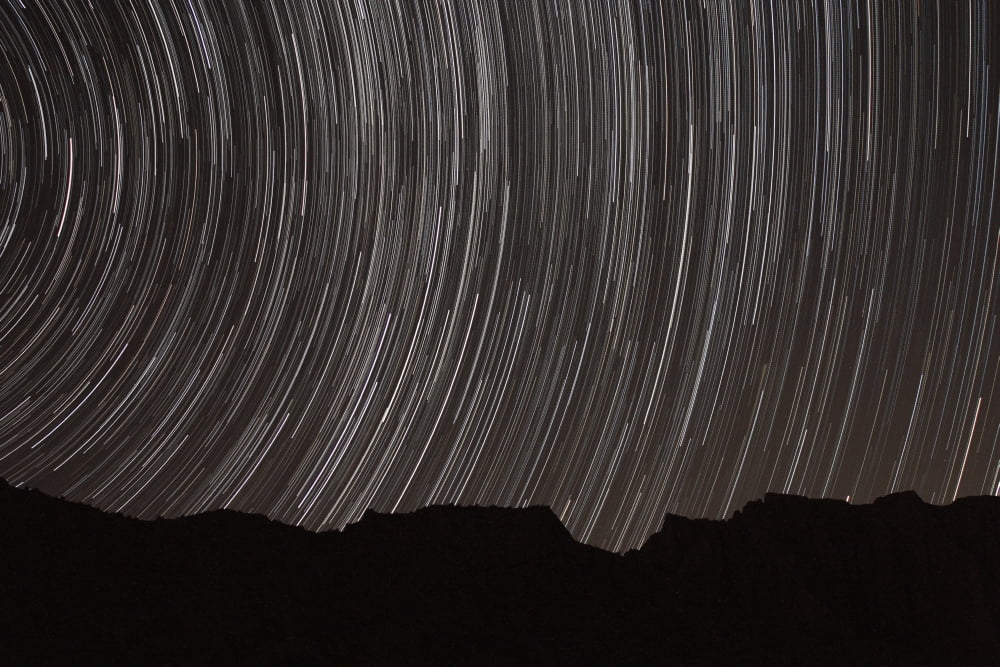 Star trails above a valley in the Firoozkooh area Iran Canvas Art - Amin JamshidiStocktrek Images (18 x 12)