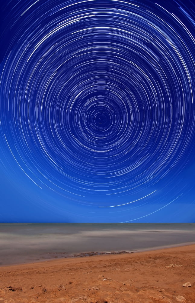 Star trails around the south celestial pole at the beach in Miramar Argentina Canvas Art - Luis ArgerichStocktrek Images (12 x 18)