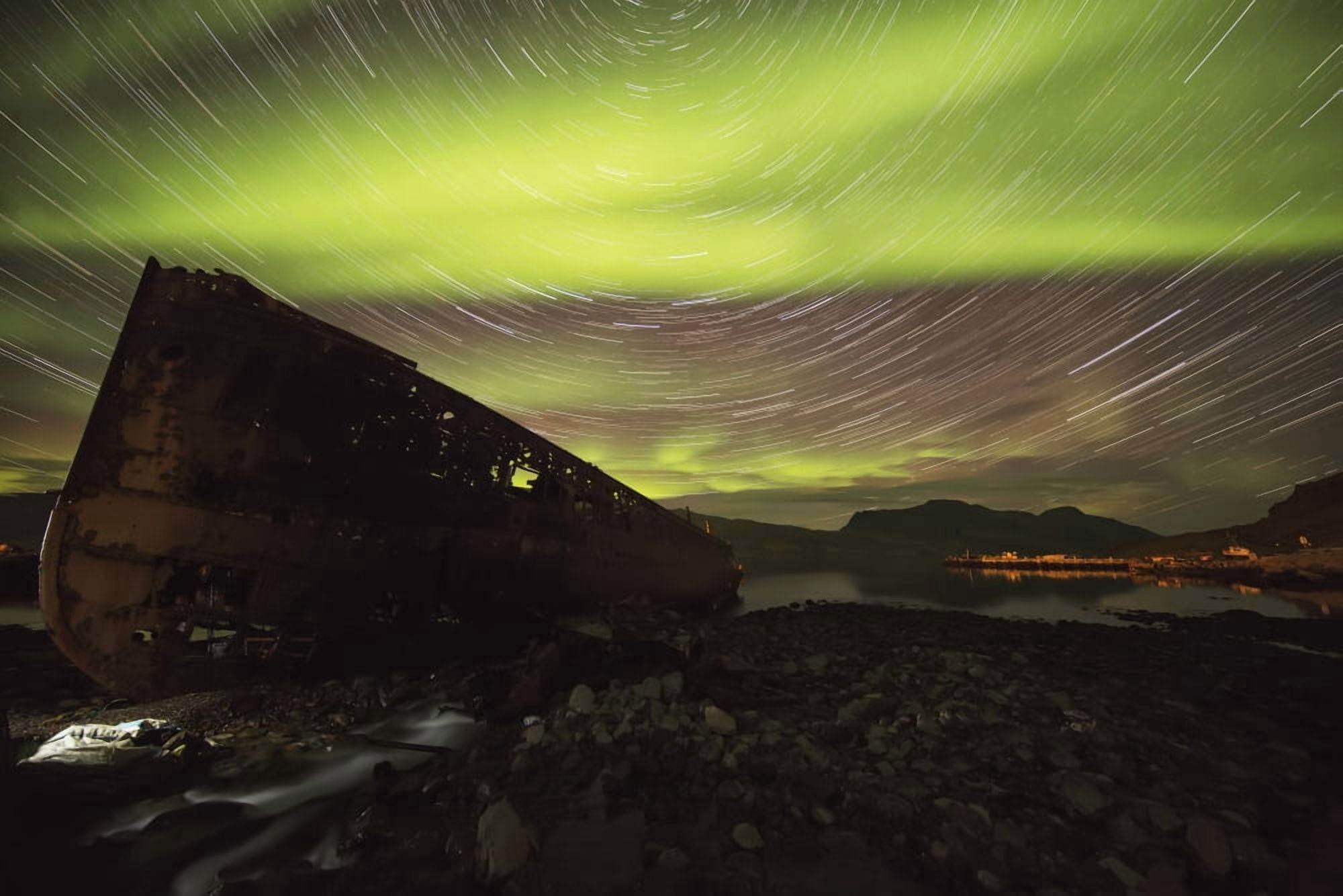 Star trails and northern lights over top the town of Djupavik in the West Fjords of Iceland Djupavik Iceland Canvas Art - Robert Postma Design Pics (38 x 24)