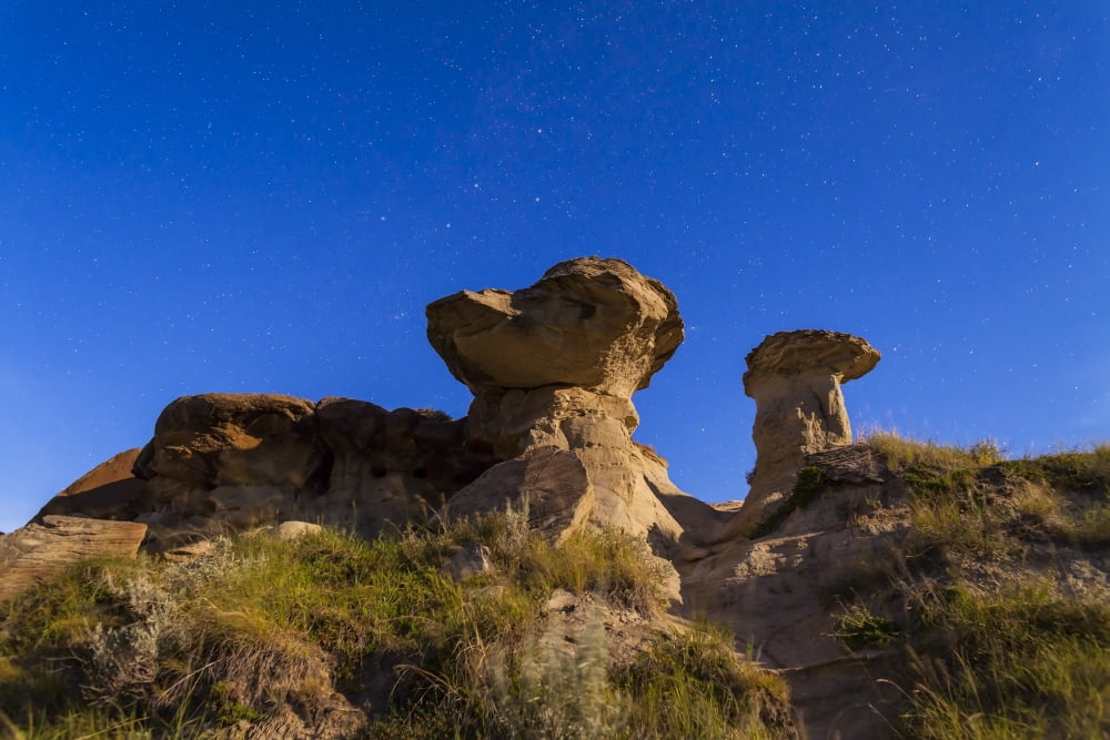 Starry sky above hoodoo formations at Dinosaur Provincial Park Canada Canvas Art - Alan DyerStocktrek Images (35 x 23)