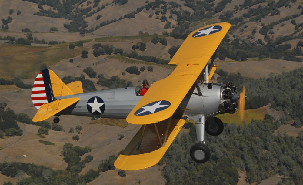 Stearman PT-17 biplane flying over Santa Rosa California Canvas Art - Phil WallickStocktrek Images (18 x 11)