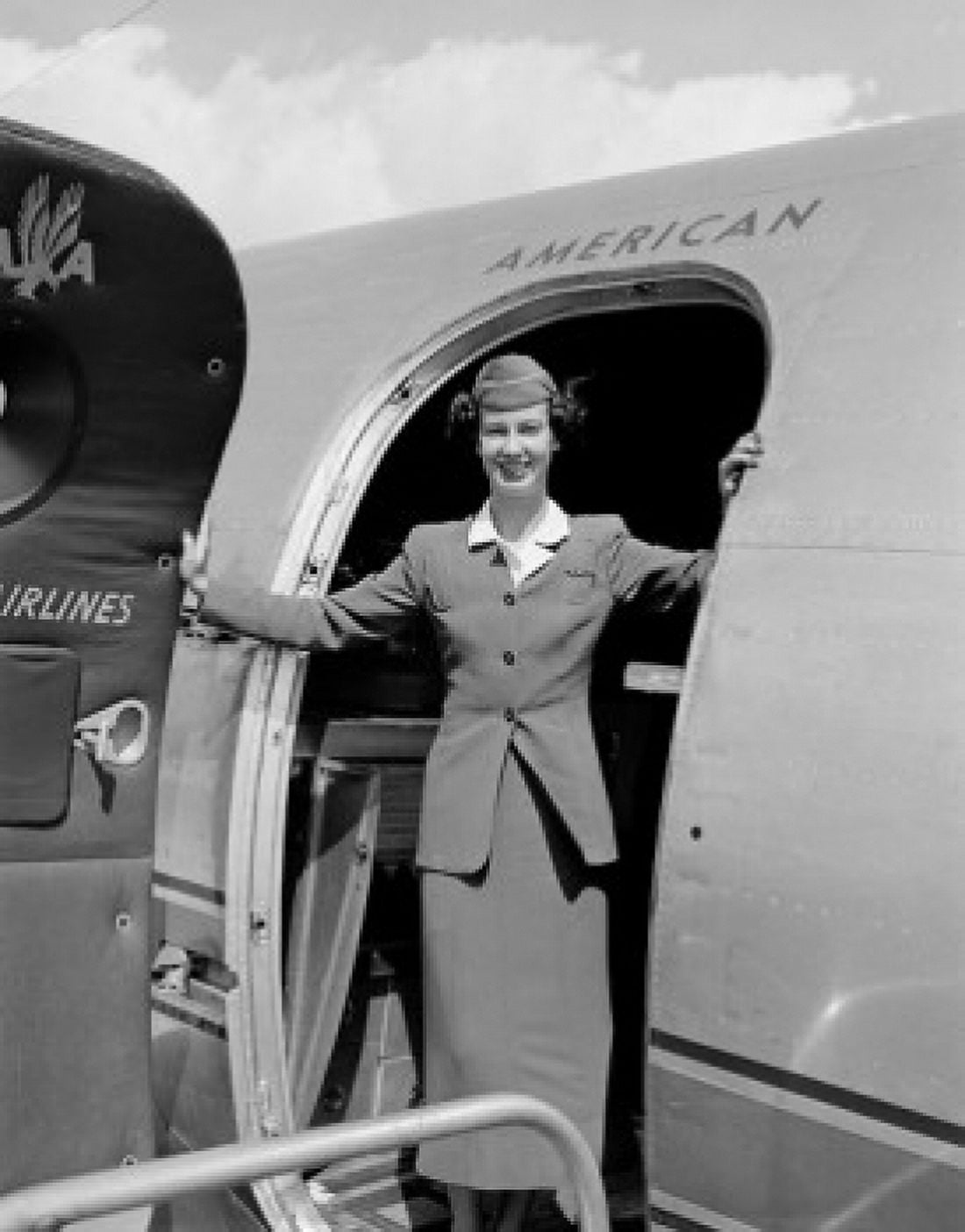 Stewardess standing in door of plane Canvas Art - (24 x 36)