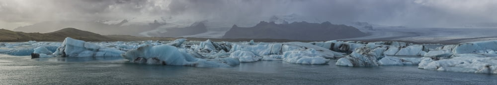 Stitched panoramic image of the Jokulsarlon glacial lagoon along the Southern coast of Iceland Iceland Canvas Art - Robert Postma Design Pics (52 x 8)