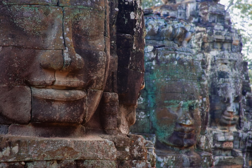 Stone Heads At Bayon Temple Canvas Art - Carson Ganci Design Pics (17 x 11)