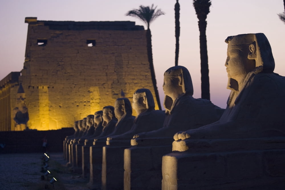 Stone Statues And The Luxor Temple On The East Bank Of Luxor Along The Nile River Luxor Egypt Canvas Art - Sean White Design Pics (38 x 24)