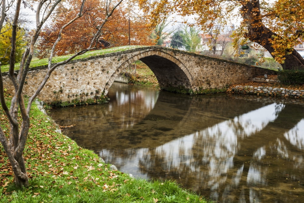 Stone bridge over a tranquil river Edessa Greece Canvas Art - Reynold Mainse Design Pics (19 x 12)