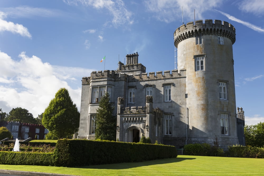 Stone castle with turret manicured grass gardens fountain blue sky and clouds County Clare Ireland Canvas Art - Michael Interisano Design Pics (38 x 24)