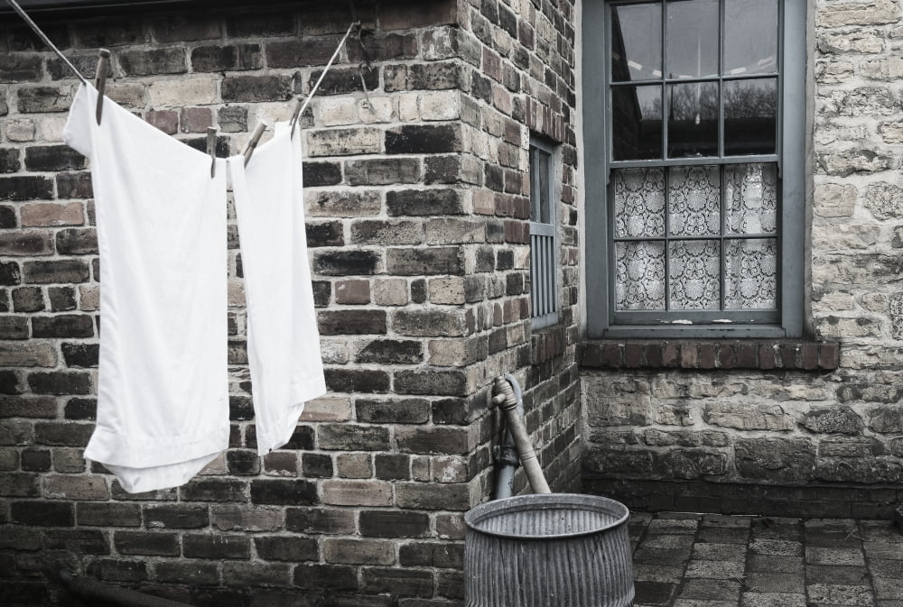 Stone walls of a house with laundry hanging to dry on the clothesline Beamish Durham England Canvas Art - John Short Design Pics (38 x 24)