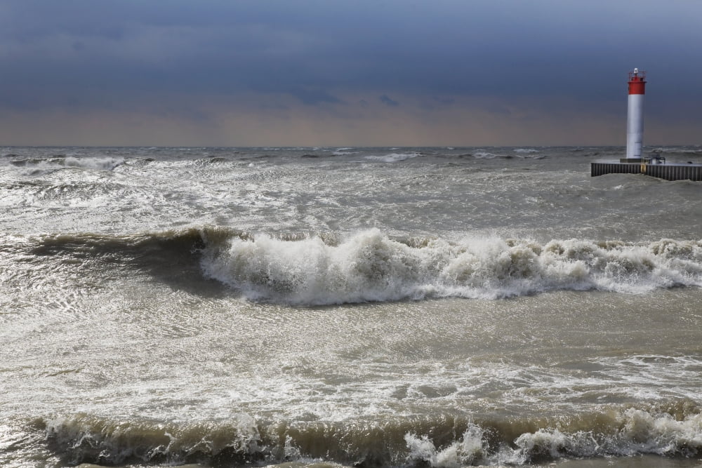 Storm waves crashing on a beach near a lighthouse on lake ontario whitby ontario canada Canvas Art - Mary Ellen McQuay Design Pics (19 x 12)