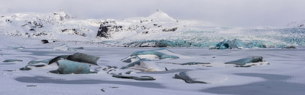 Stormy sky over icebergs in frozen lagoon Breidamerkurjokull glacier Vatnajokull Iceland Canvas Art - Panoramic Images (27 x 9)
