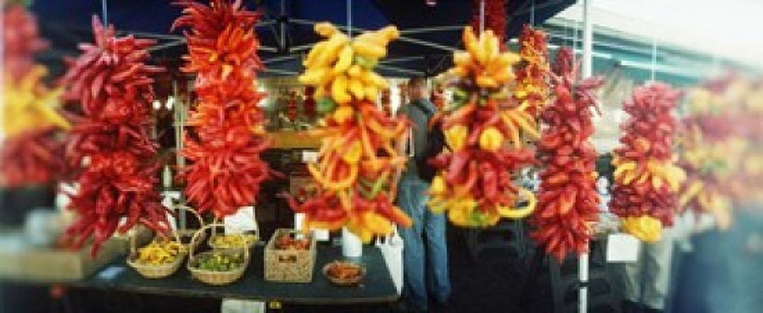 Strands of chili peppers hanging in a market stall, Pike Place Market ...