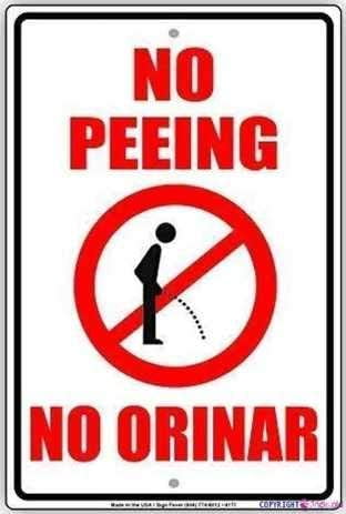 Street sign warning plaque No Peeing No Orinar English Spanish With
