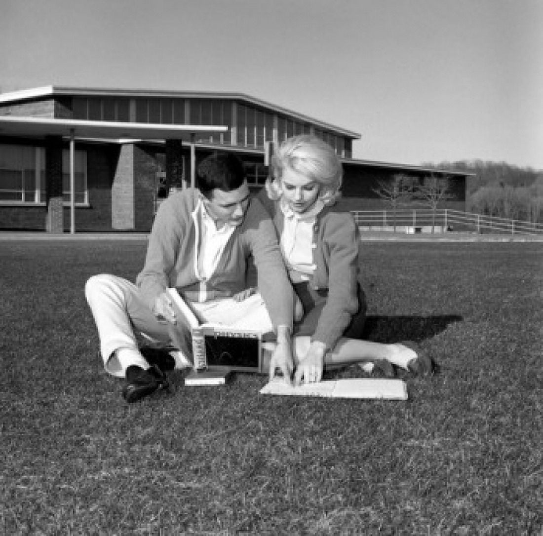 Students couple sitting on grass and learning Canvas Art - (18 x 24)